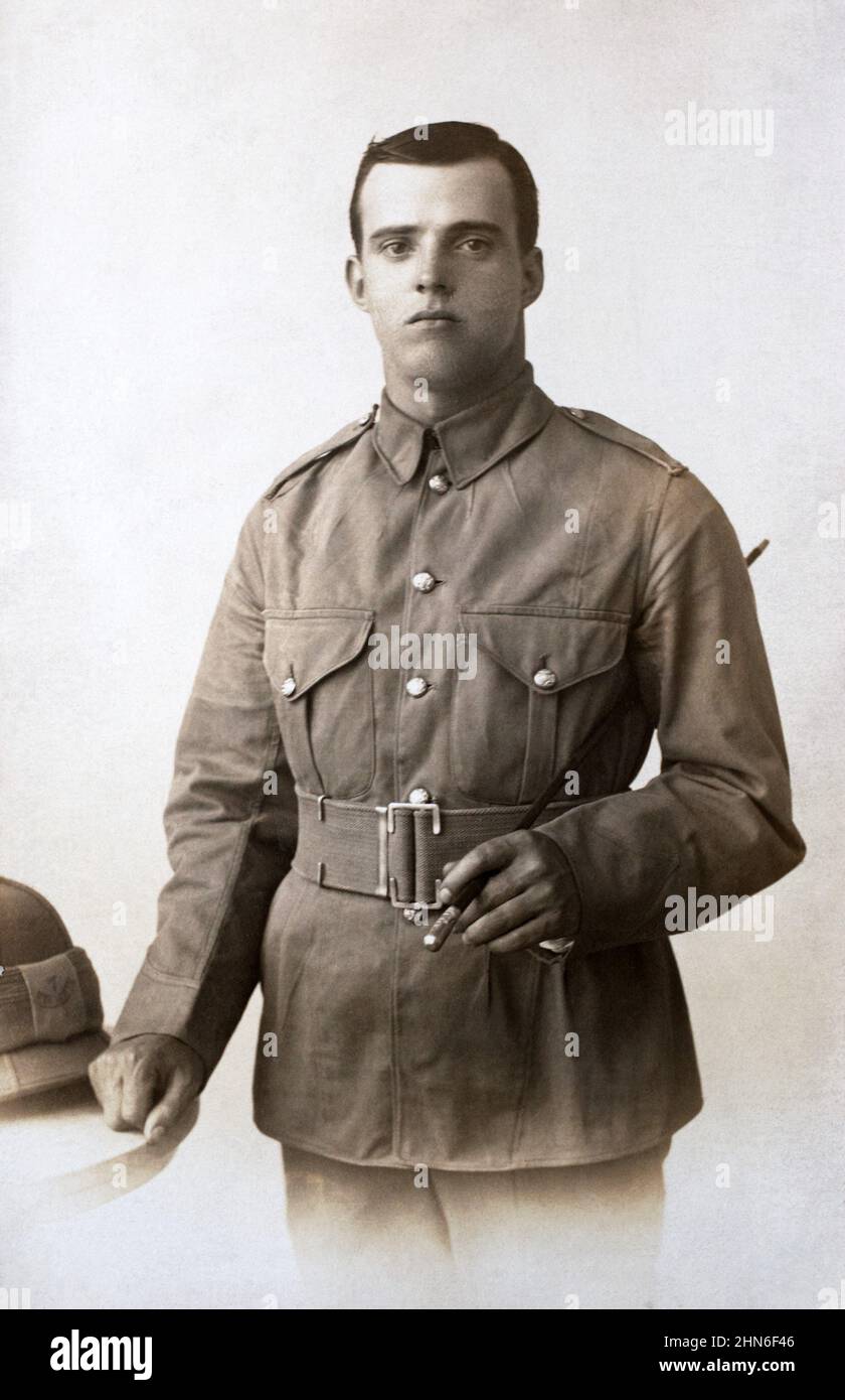 A historical picture of British army infantryman posing with a pith helmet and swagger stick, c. First World War. Stock Photo