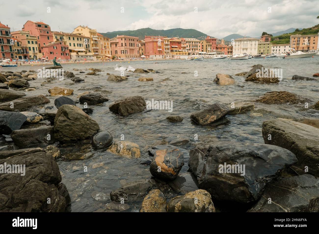 Scenic view of the rocks in bay of the Silence in Sestri Levante, Liguria, Italy across the colorful houses, mountains and coastline Stock Photo