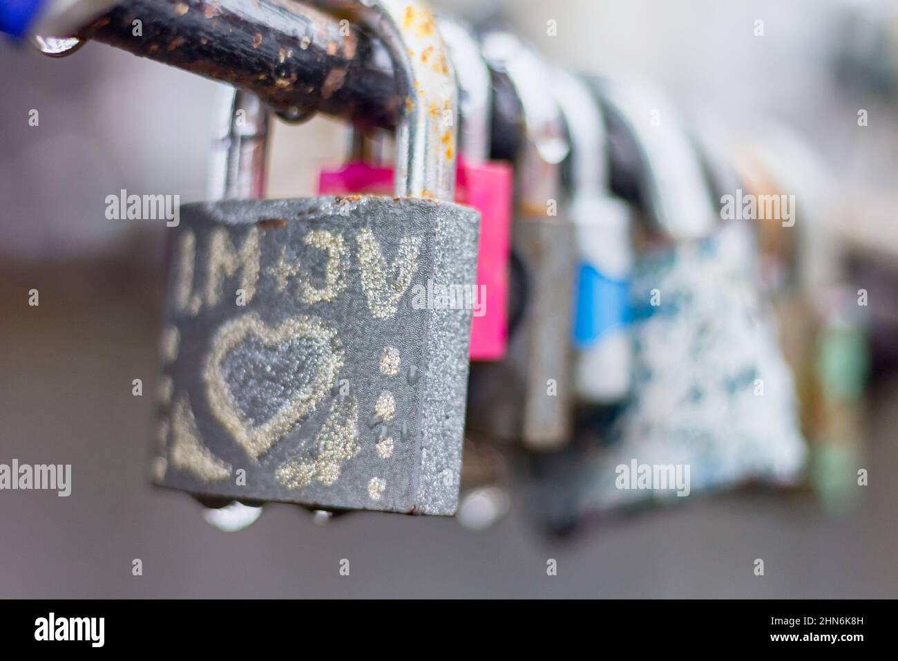 Love padlocks with drops of rain in close-up view. Stock Photo