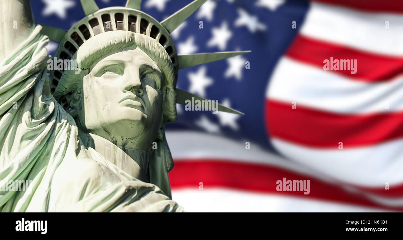 the statue of liberty with blurred american flag waving in the background. Democracy and freedom concept. Stock Photo