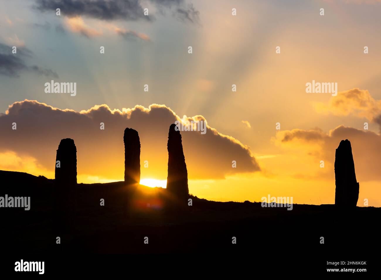 Orkney Islands, Scotland, UK. 14th Feb, 2022. The sun sets dramatically behind some of the stones of the Ring of Brodgar, a World Heritage Site, in Orkney, Scotland. The neolithic stone circle, of which only 36 survive from the original 60 4m high monoliths, is believed to date back to 2500BC. Credit: Peter Lopeman/Alamy Live News Stock Photo