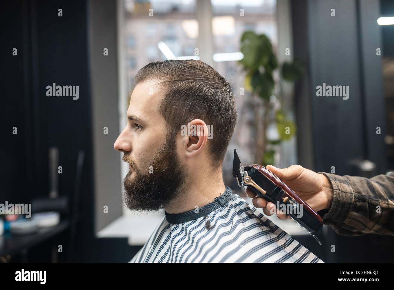 Master in makes men's haircutting with hair clipper Stock