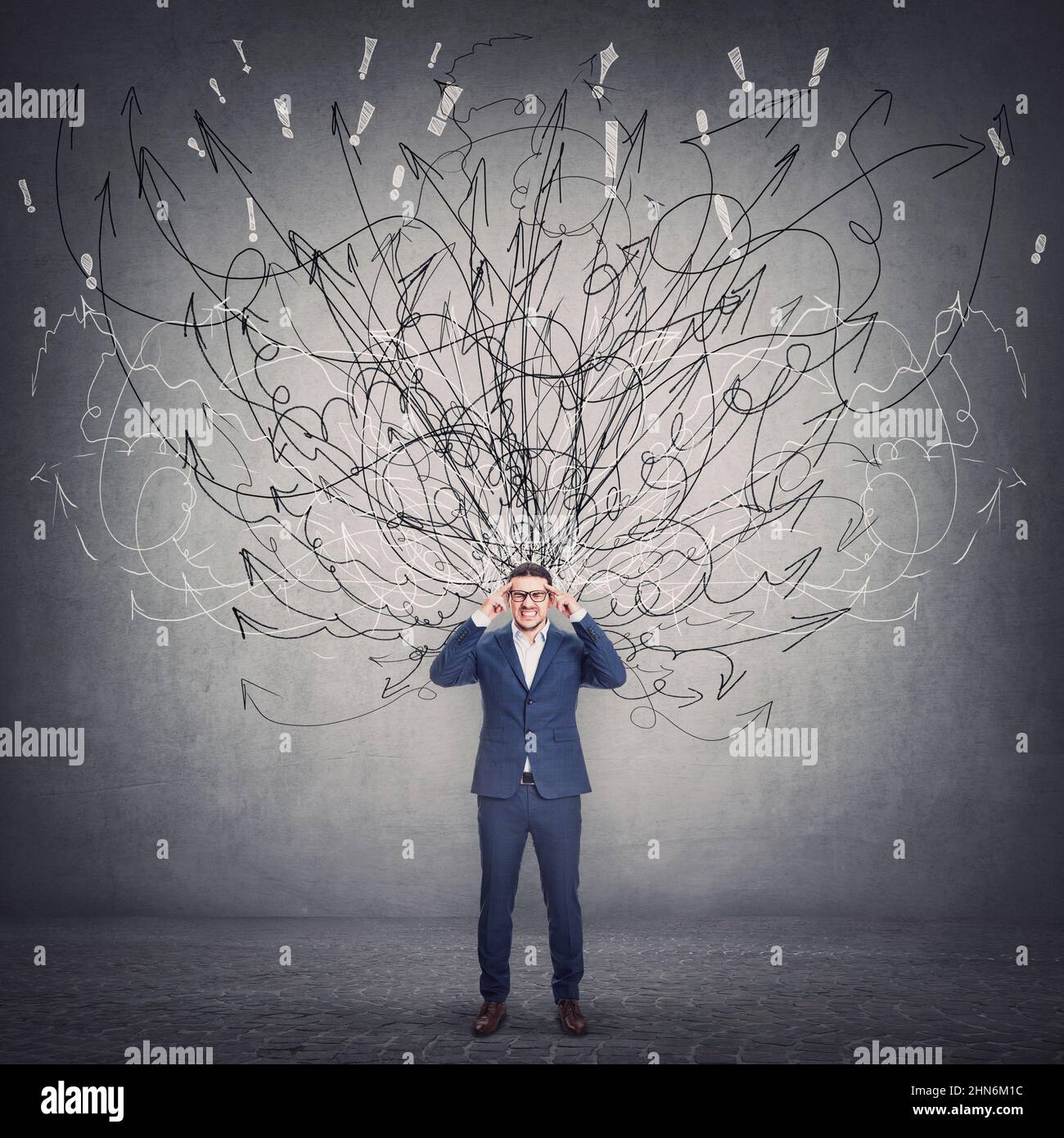 Businessman focusing on a difficult task, hard thinking concept with mess sketches coming out of the person head. Anxiety and mental health problems Stock Photo