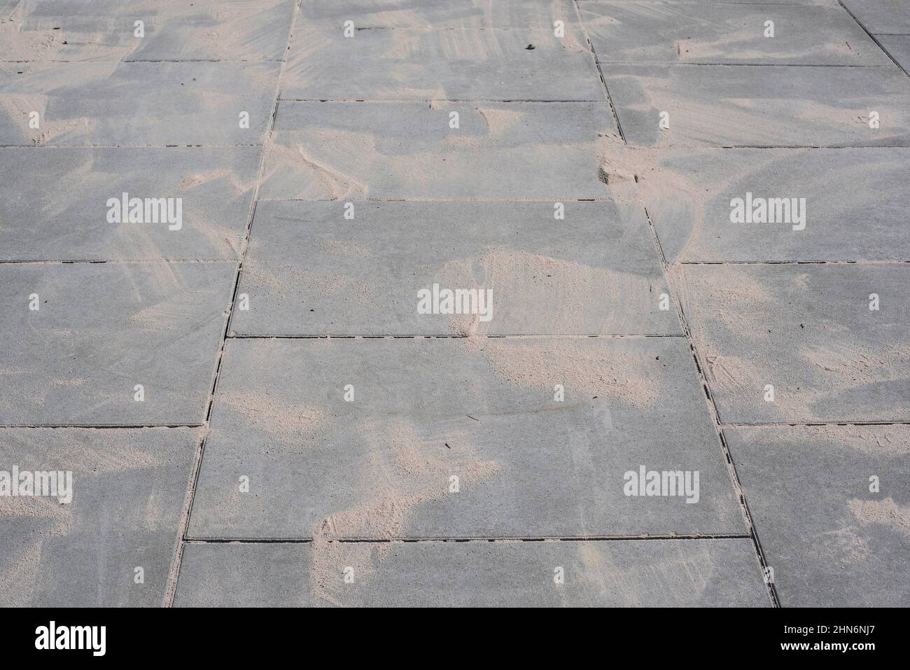 sand for filling of the gaps between paving plates on a sidewalk Stock