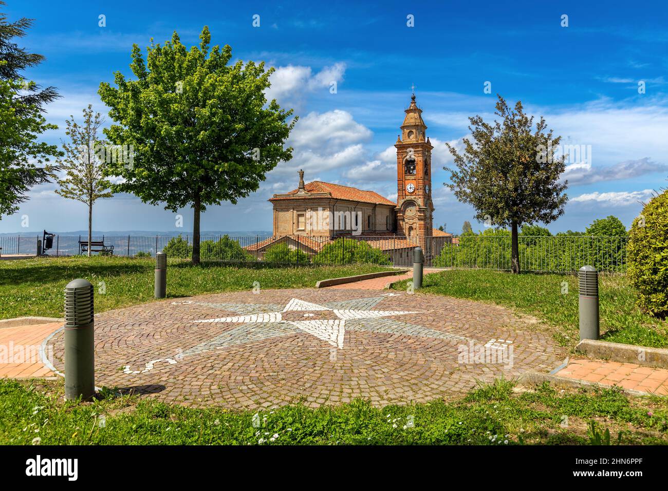 View from the park of old parish church under beautiful sky in small town of Diano d'Alba in Piedmont, Northern Italy. Stock Photo