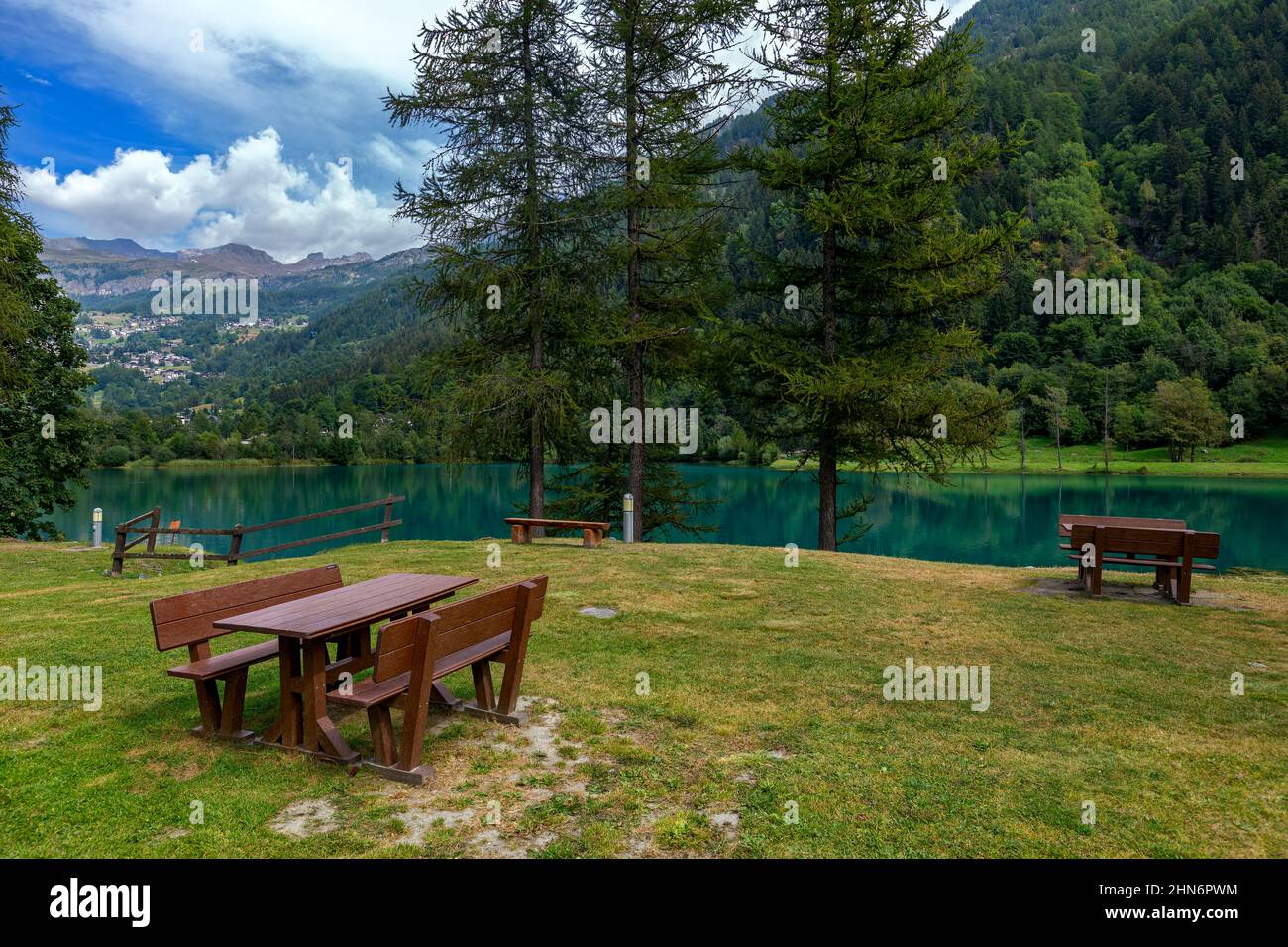 Picnic tables on the shore of the alpine Lake Maen in Aosta Valley region in Northern Italy. Stock Photo