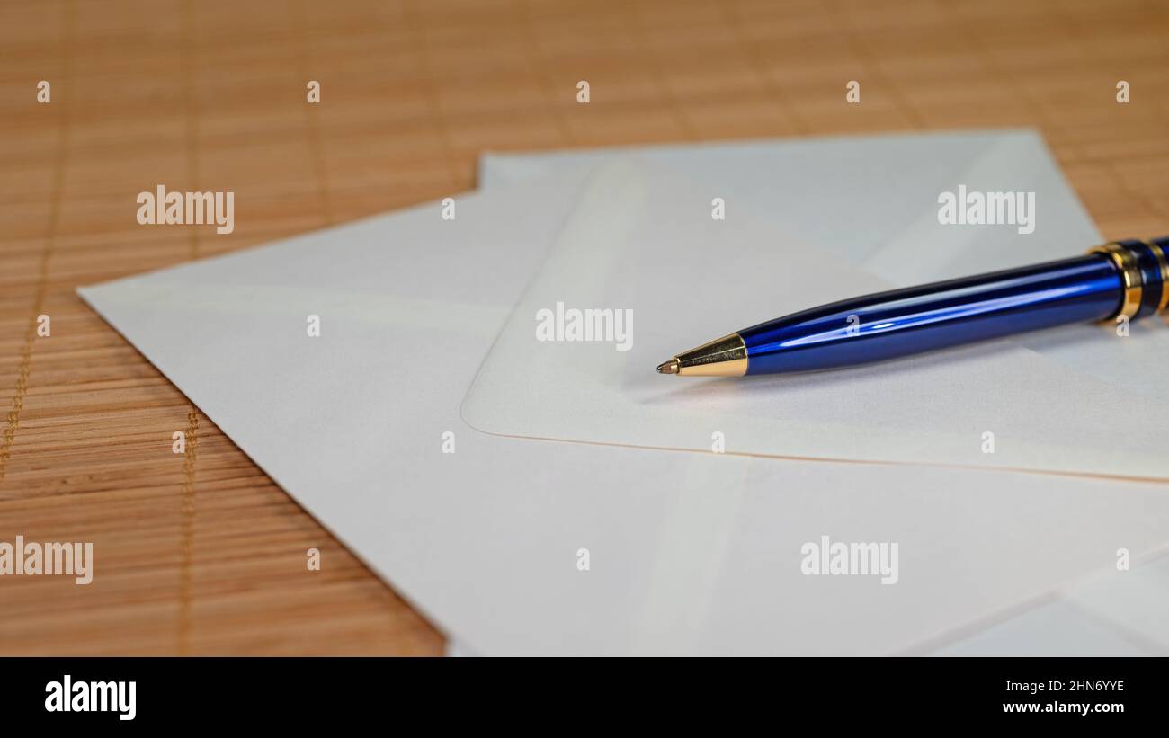 Pen and envelopes in close-up Stock Photo