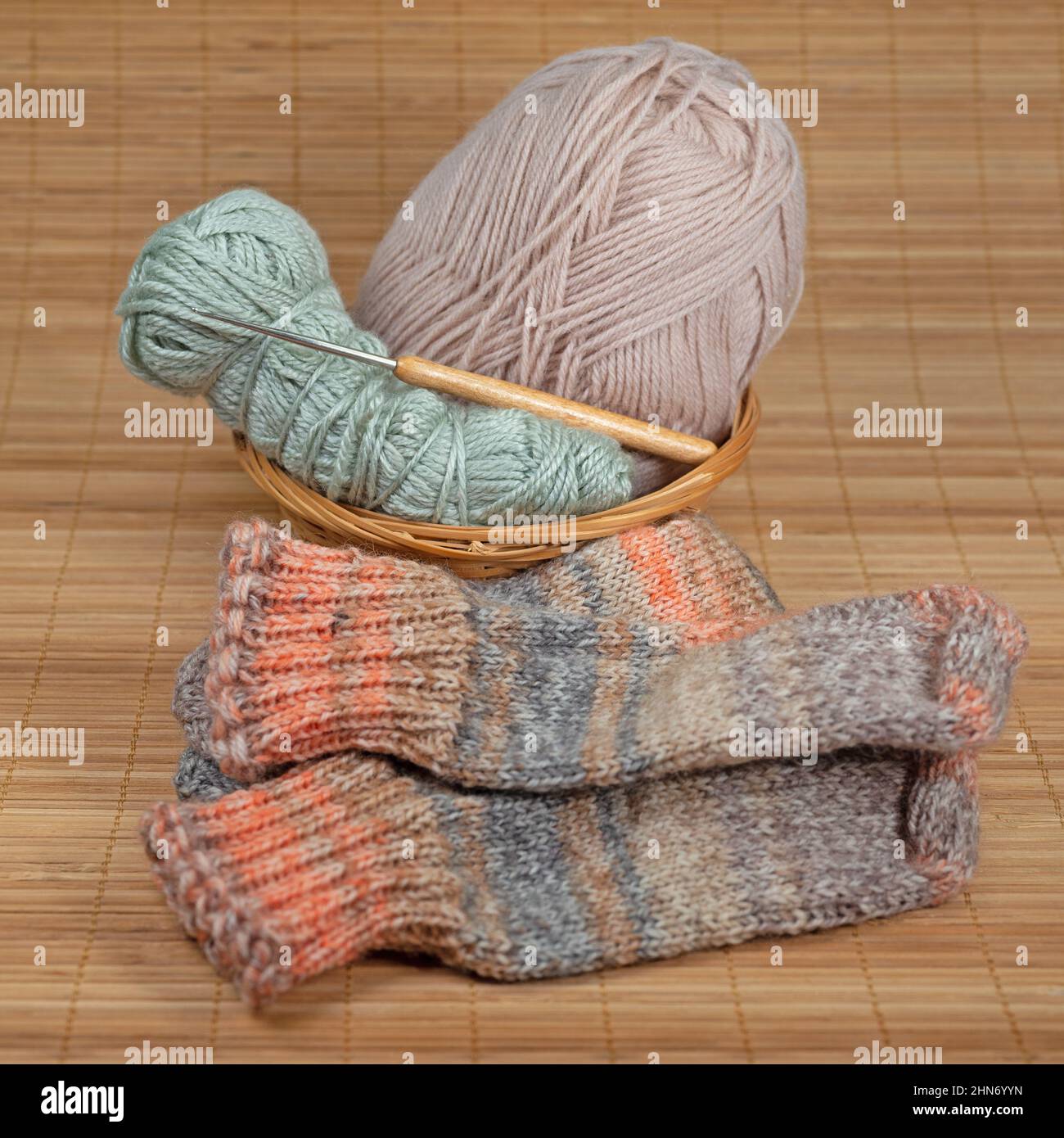 Crochet yarn, crochet hook and crocheted socks Stock Photo Alamy