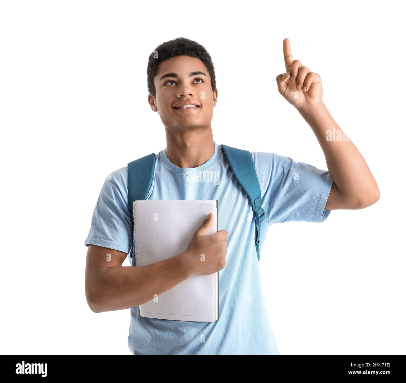 Male African-American student with notebook pointing at something on white background Stock Photo