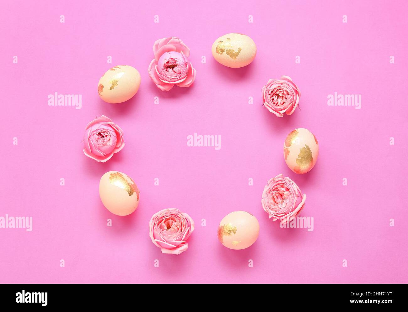 Frame made of Easter eggs and flowers on pink background Stock Photo ...