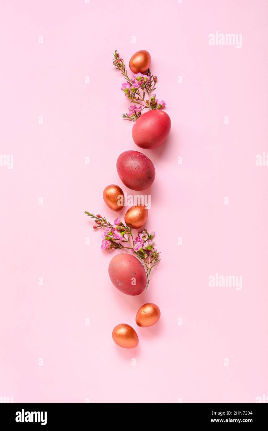 Composition with Easter eggs and flowers on pink background Stock Photo ...