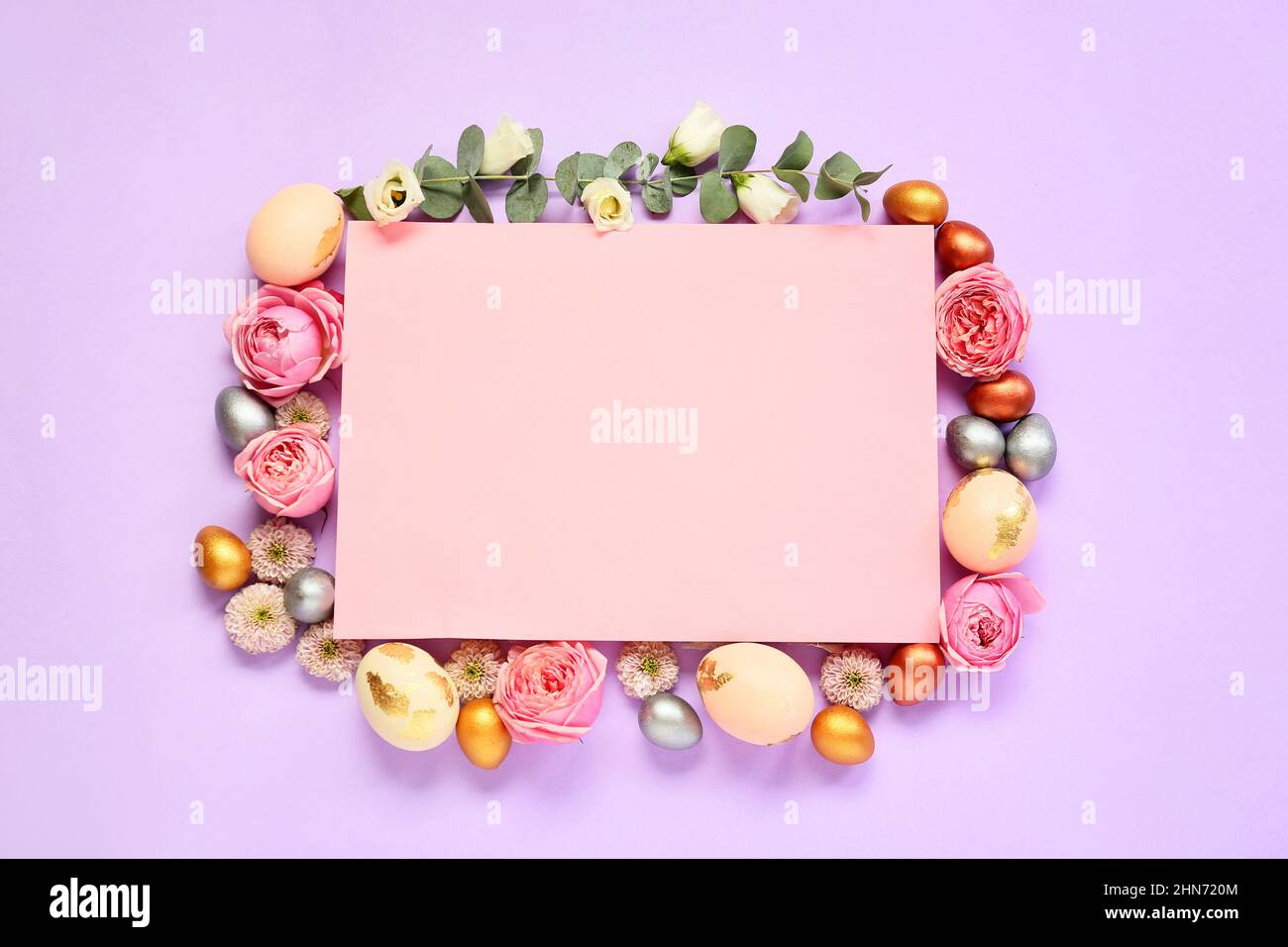 Frame made of sheet of paper, Easter eggs and flowers on purple ...