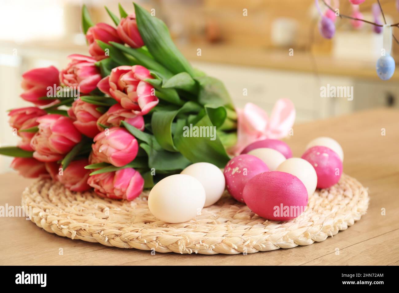 Easter eggs and bouquet of tulips on wooden counter Stock Photo - Alamy