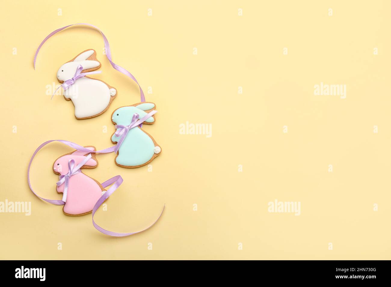 Delicious Easter cookies in shape of bunny on beige background Stock Photo