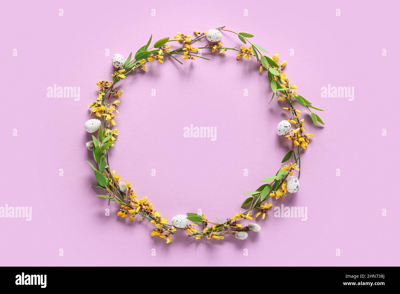 Beautiful wreath with Easter eggs and flowers on purple background ...