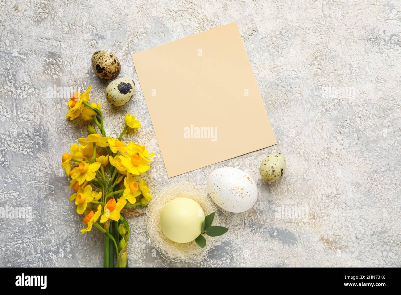 Beautiful Easter composition with blank card, eggs and flowers on light ...