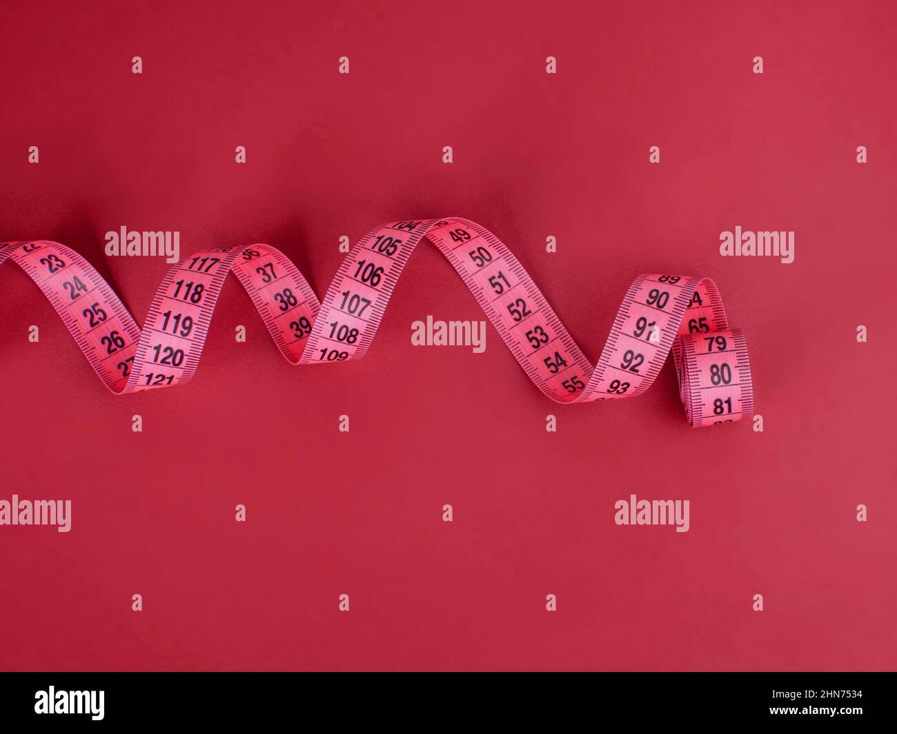 Purple tape measure on the violet background Stock Photo - Alamy