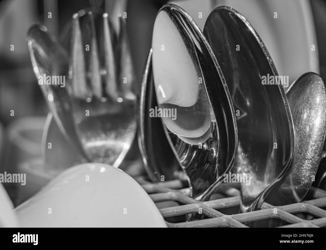 Dishes and cutlery cleaned in a dishwasher Stock Photo