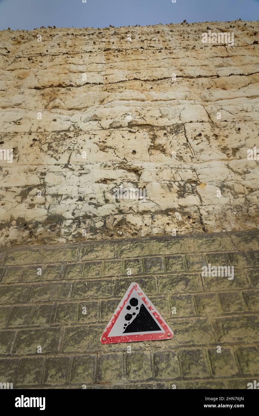Warning of falling rocks on a chalk cliff face Stock Photo