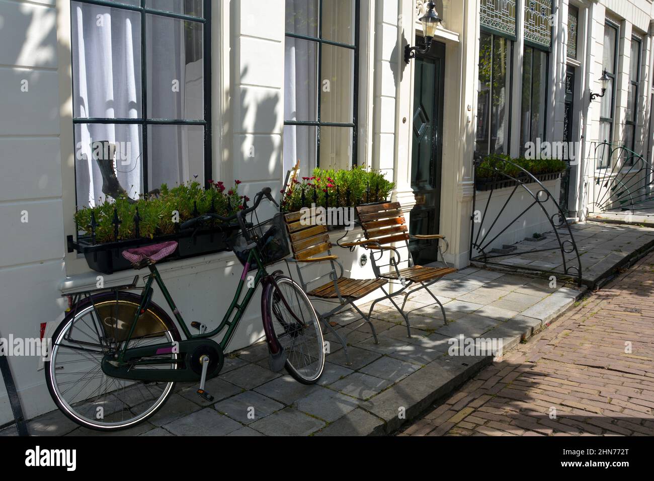 Typical Holland - bicycle leaning against a house facade on Zeeland in the Netherlands Stock Photo