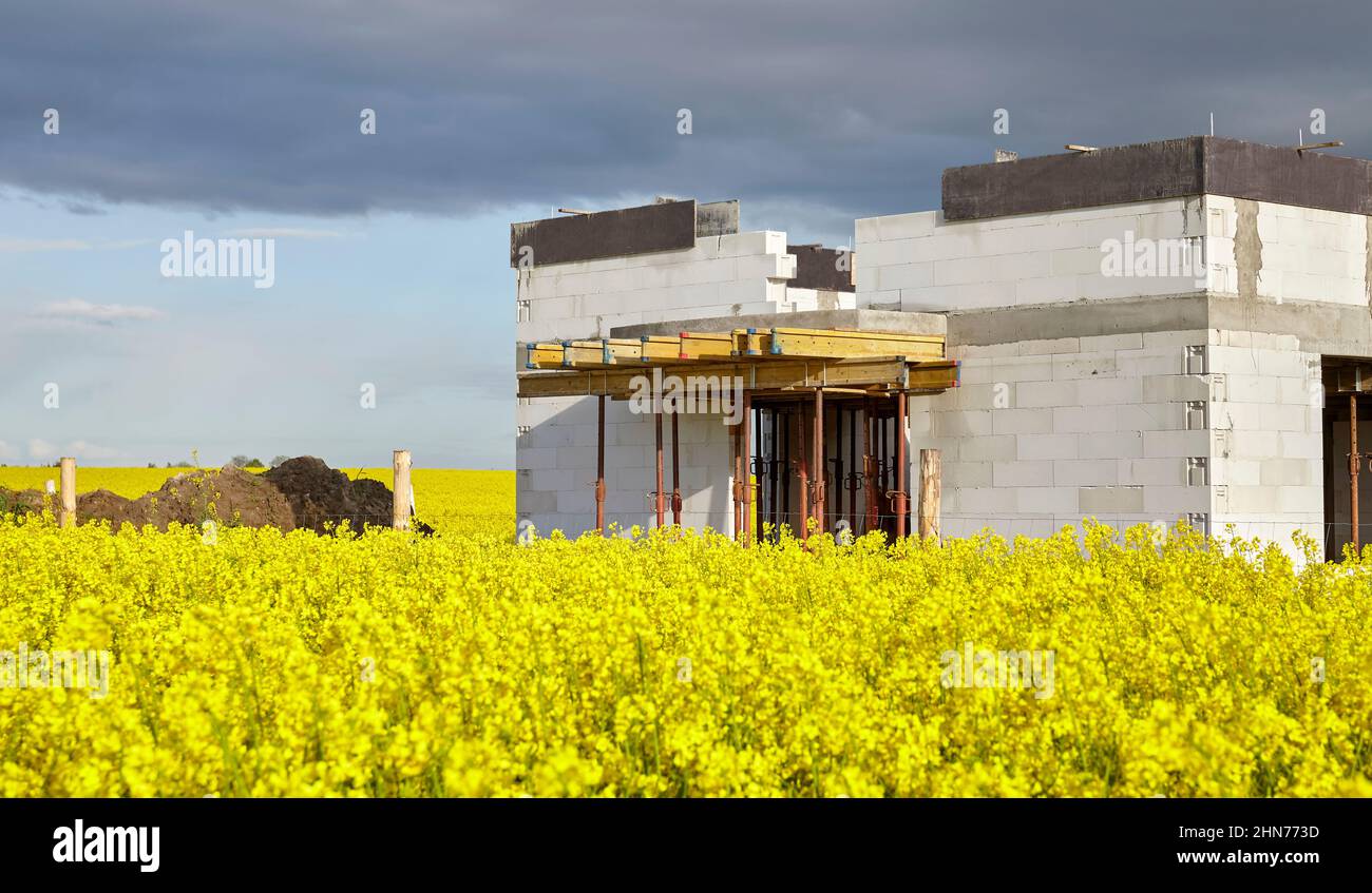 Rural house under construction in rapeseed field Stock Photo Alamy