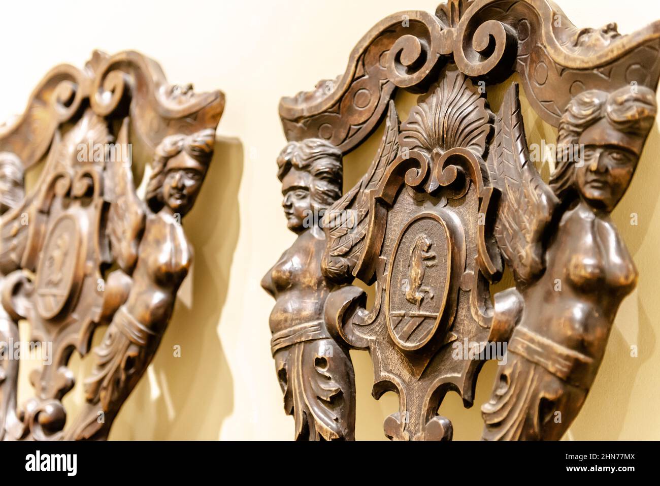 Antique carved armchair. An old 17th century armchair from Southern Germany. Oak antique furniture close-up. Stock Photo