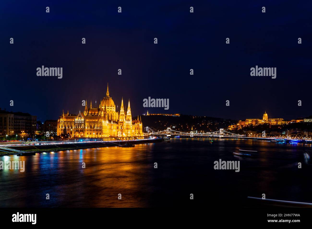 Wonderful mesmerizing view of the city at night illuminated by lights on the danube river. Wonderful architecture at night. Beautiful landscape on the Stock Photo