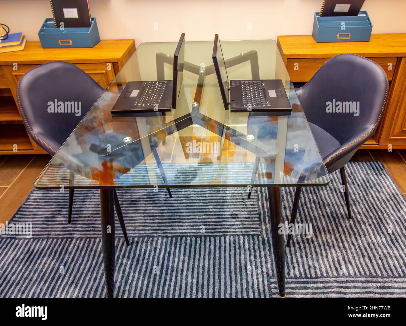 Home Office Glass Table With Two Laptops Stock Photo