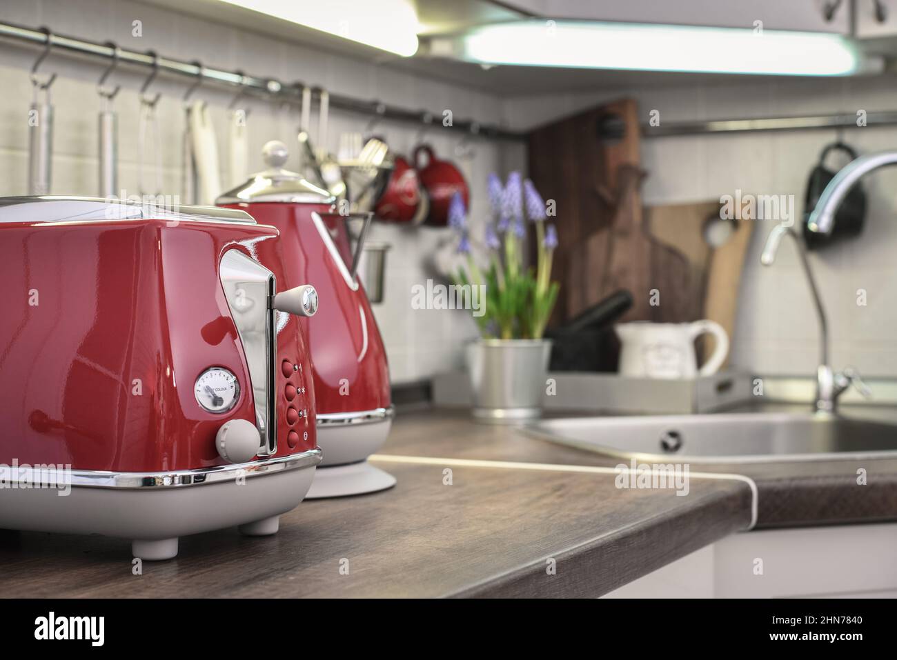 https://c8.alamy.com/comp/2HN7840/red-toaster-and-electric-kettle-in-retro-slile-on-tabletop-in-kitchen-interior-2HN7840.jpg