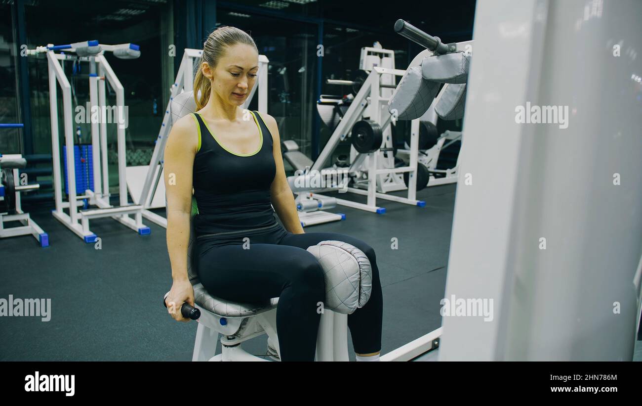 Fit Athletic Woman Girl Work out in Adduction Inner Thigh Machine