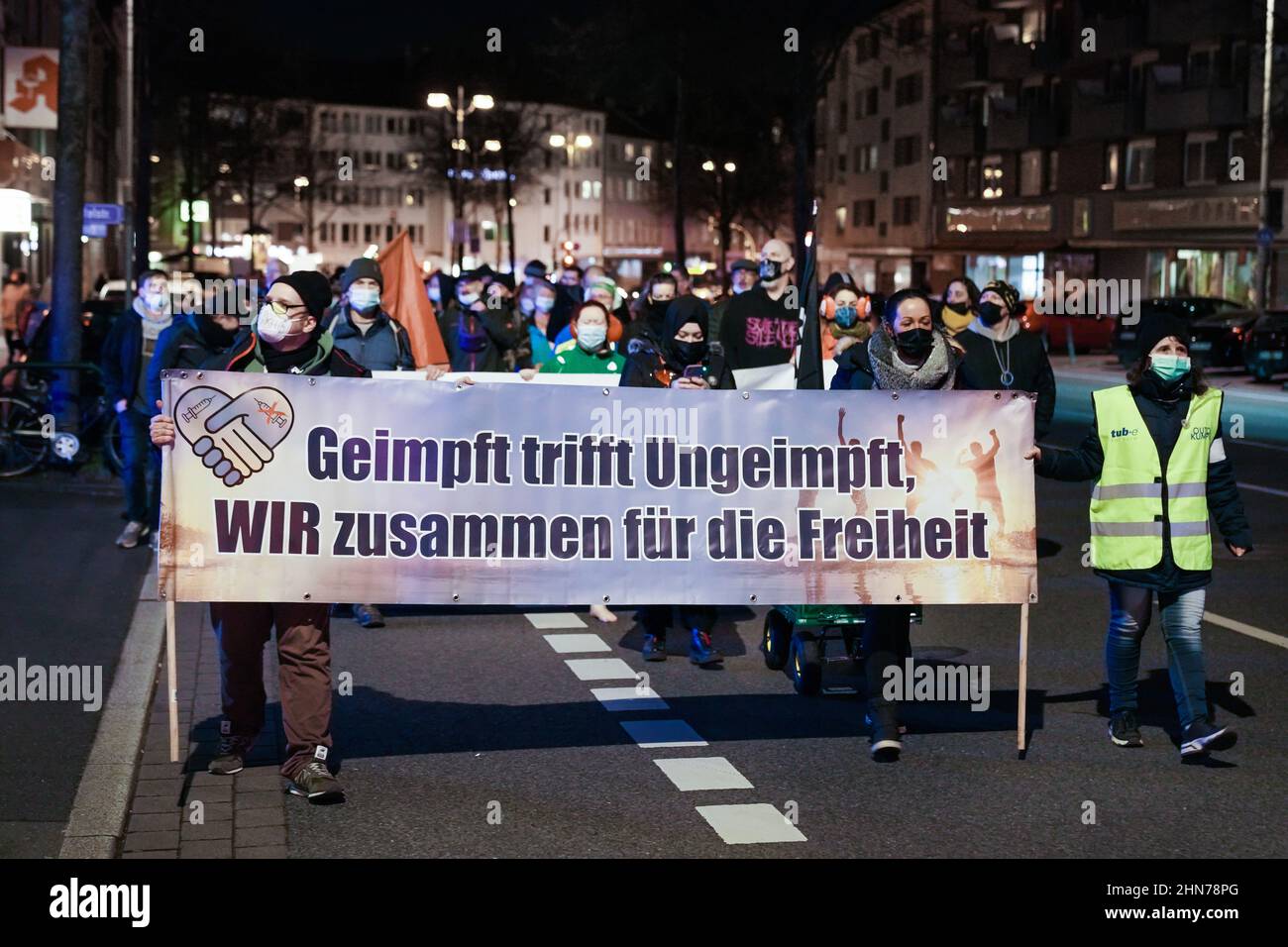 Dortmund, Germany, February 14th, 2022: Opponents of the corona protection measures march through the city center of Dortmund on Monday evening at an approved demonstration.   ---   Dortmund, 14.2.2022: Gegner der Corona-Schutzmaßnahmen ziehen am Montagabend bei einer genehmigten Demonstration durch die Dortmunder Innenstadt. Stock Photo