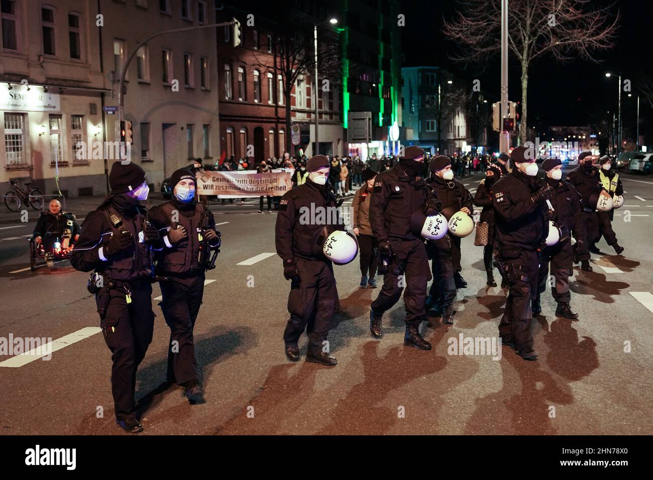 Dortmund, Germany, February 14th, 2022: Opponents of the corona protection measures march through the city center of Dortmund on Monday evening at an approved demonstration.   ---   Dortmund, 14.2.2022: Gegner der Corona-Schutzmaßnahmen ziehen am Montagabend bei einer genehmigten Demonstration durch die Dortmunder Innenstadt. Stock Photo