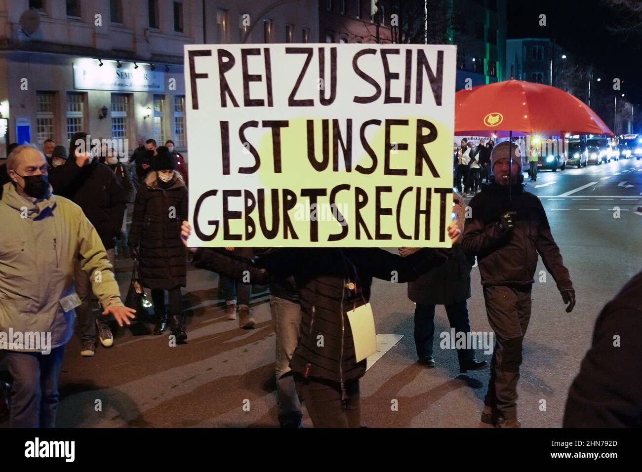 Dortmund, Germany, February 14th, 2022: Opponents of the corona protection measures march through the city center of Dortmund on Monday evening at an approved demonstration.   ---   Dortmund, 14.2.2022: Gegner der Corona-Schutzmaßnahmen ziehen am Montagabend bei einer genehmigten Demonstration durch die Dortmunder Innenstadt. Stock Photo