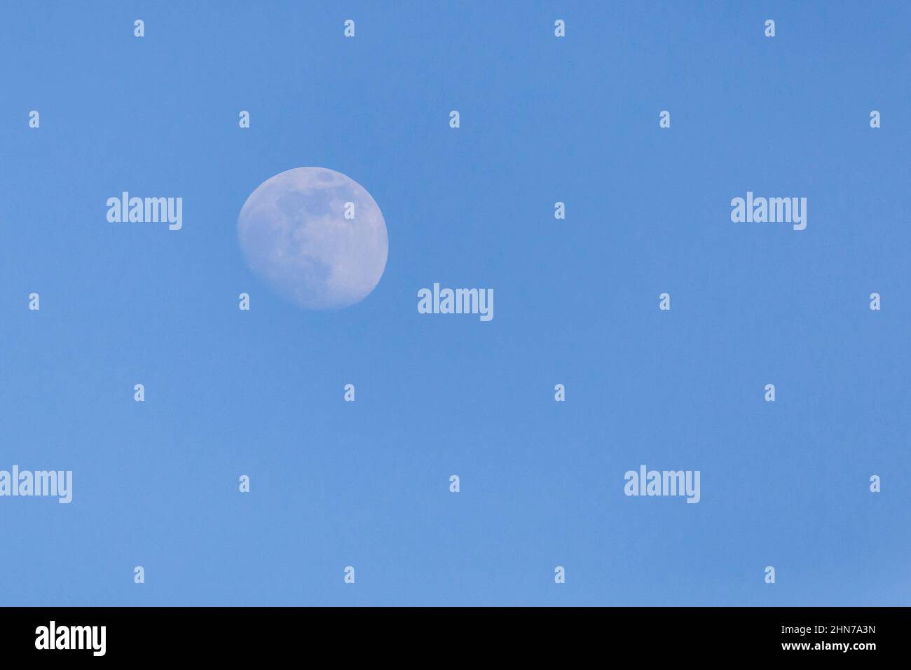view of the waxing crescent moon in a blue sky Stock Photo
