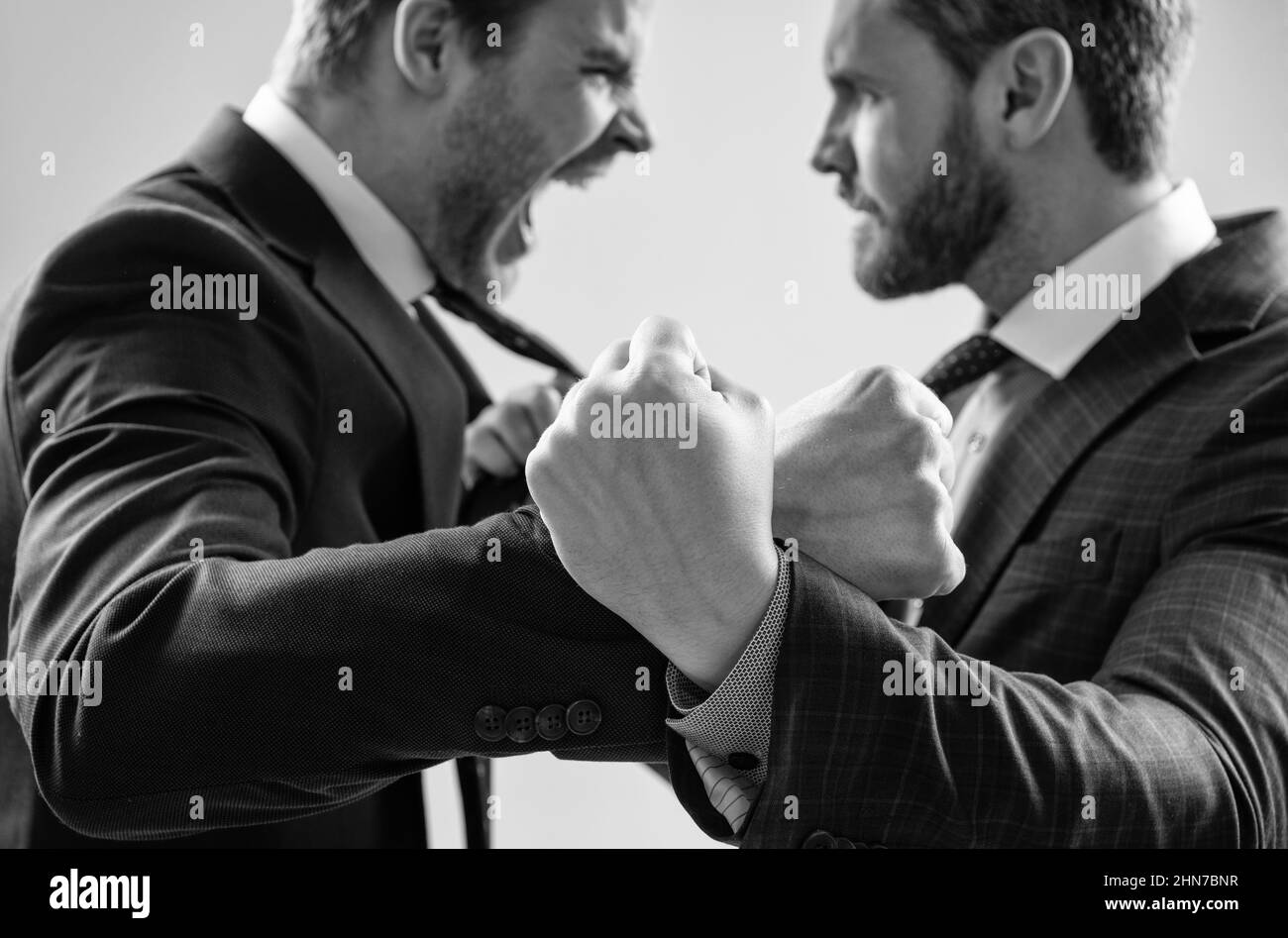 fist of punching disagreed men business partners or colleague disputing, selective focus, corporate battle. Stock Photo