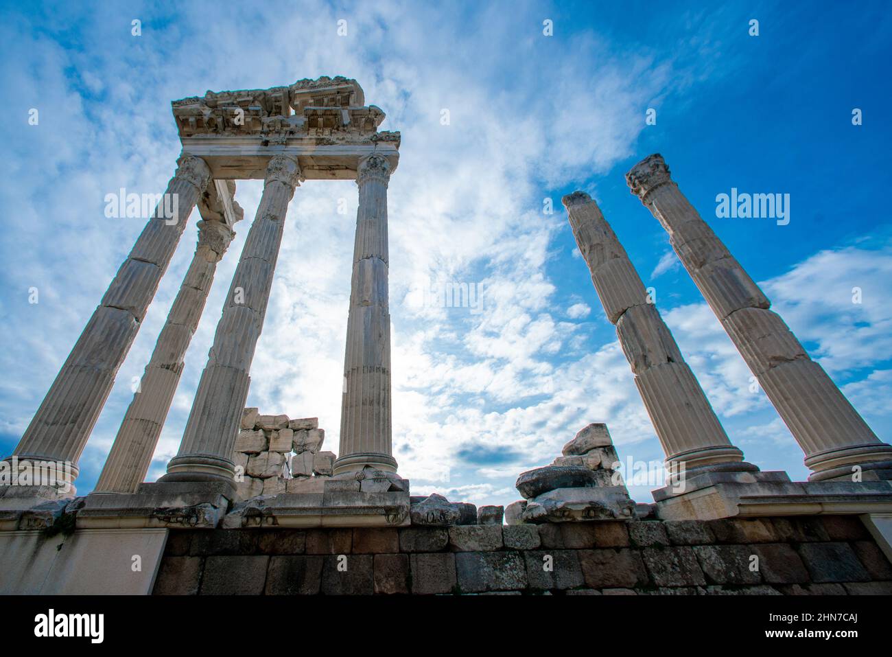 Ancient ruins against a bright blue sky. Tall antique columns. Destroyed buildings. Turkey, izmir Stock Photo