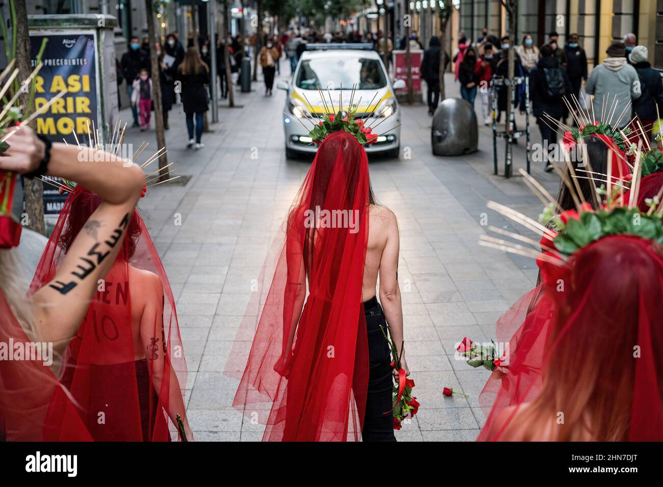 Madrid, Spain. 14th Feb, 2022. The Madrid Municipal Police stops female activists from FEMEN Spain during a protest on Fuencarral street, Madrid. A group of feminist activists from FEMEN, Spain demonstrate in the framework of Valentine's Day to denounce the latest femicides in Spain. Credit: SOPA Images Limited/Alamy Live News Stock Photo