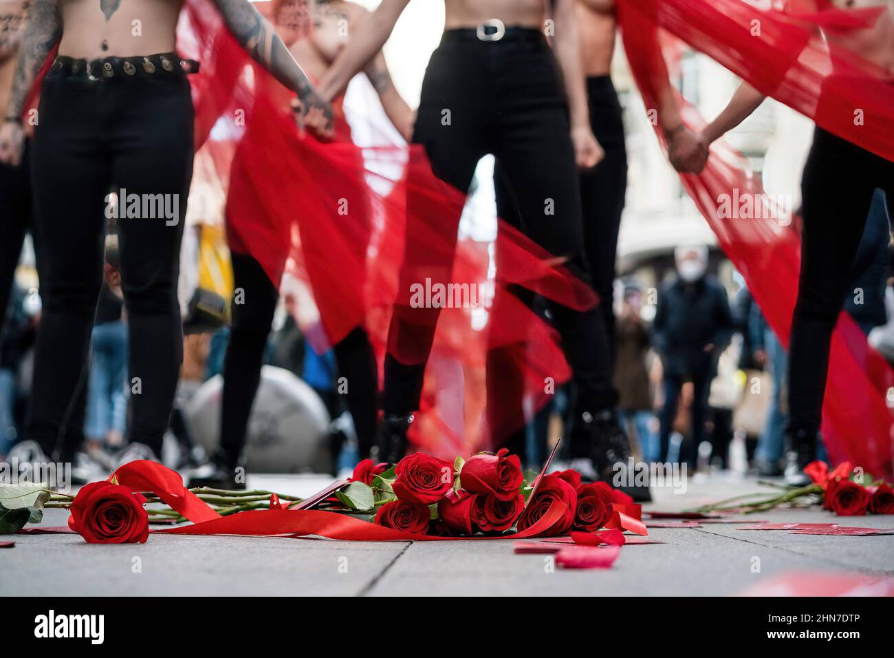 Madrid, Spain. 14th Feb, 2022. Red roses are seen in front of female activists from FEMEN Spain during a protest in Madrid's Gran Via. A group of feminist activists from FEMEN, Spain demonstrate in the framework of Valentine's Day to denounce the latest femicides in Spain. (Photo by Diego Radames/SOPA Images/Sipa USA) Credit: Sipa USA/Alamy Live News Stock Photo