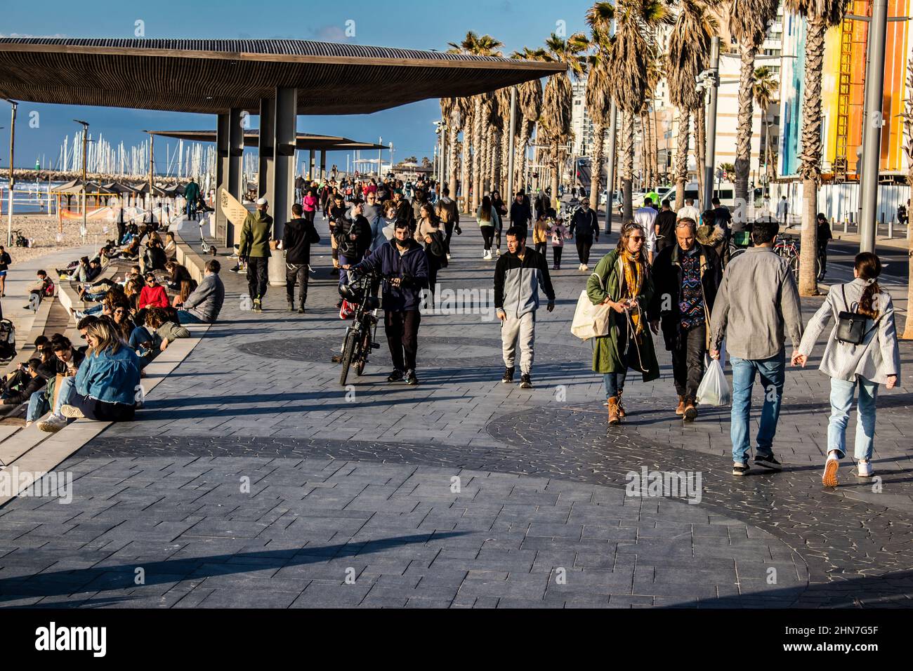 Tel Aviv, Israel - February 13, 2022 Unidentified people walking on Tel Aviv Promenade, commonly referred to in Hebrew simply as the Tayelet, runs alo Stock Photo