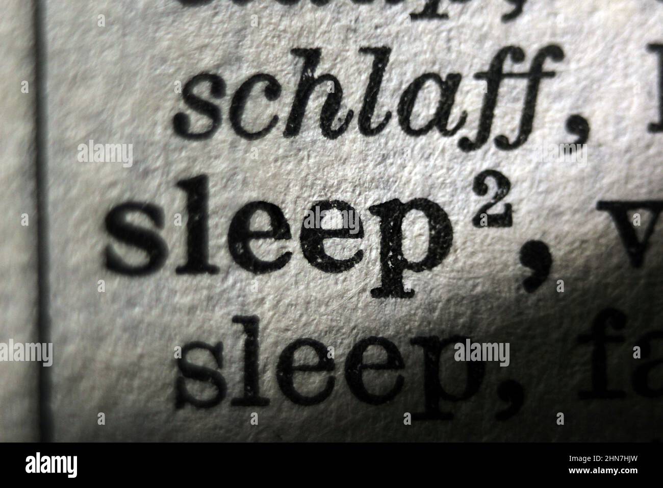 Word 'sleep' printed on dictionary page, macro close-up Stock Photo