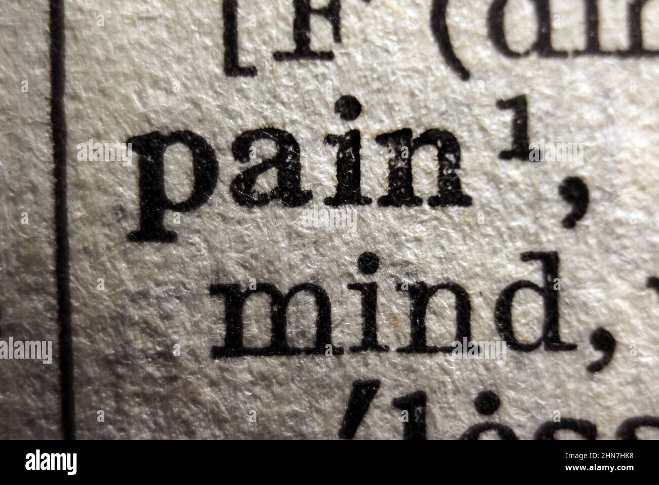Word 'pain' printed on dictionary page, macro close-up Stock Photo