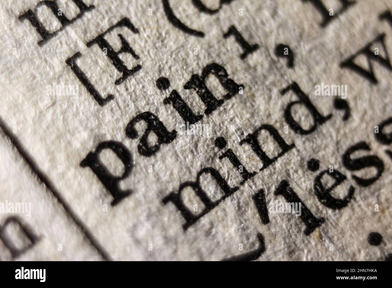 Word 'pain' printed on dictionary page, macro close-up Stock Photo