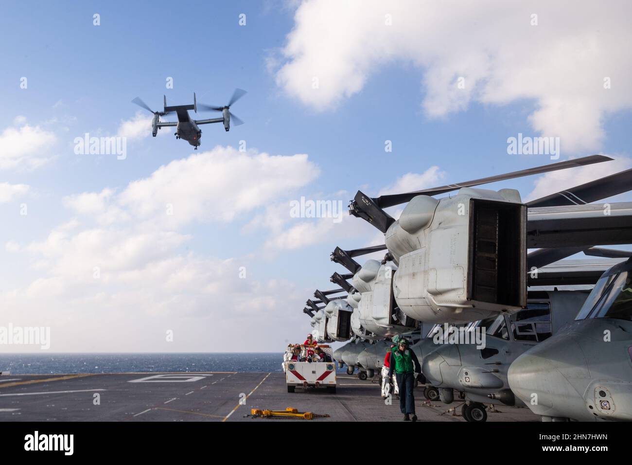 An MV-22B Osprey with Marine Medium Tiltrotor Squadron (VMM) 265 (Reinforced), 31st Marine Expeditionary Unit (MEU) carries U.S. Marines preparing to establish a forward command element in Naha, Okinawa, Japan aboard amphibious assault ship USS America, Philippine Sea, Feb. 8, 2022. The 31st MEU is operating aboard ships of the America Expeditionary Strike Group in the 7th fleet area of operations to enhance interoperability with allies and partners and serve as a ready response force to defend peace and stability in the Indo-Pacific Region. (U.S. Marine Corps photo by Lance Cpl. Cesar Ronaldo Stock Photo