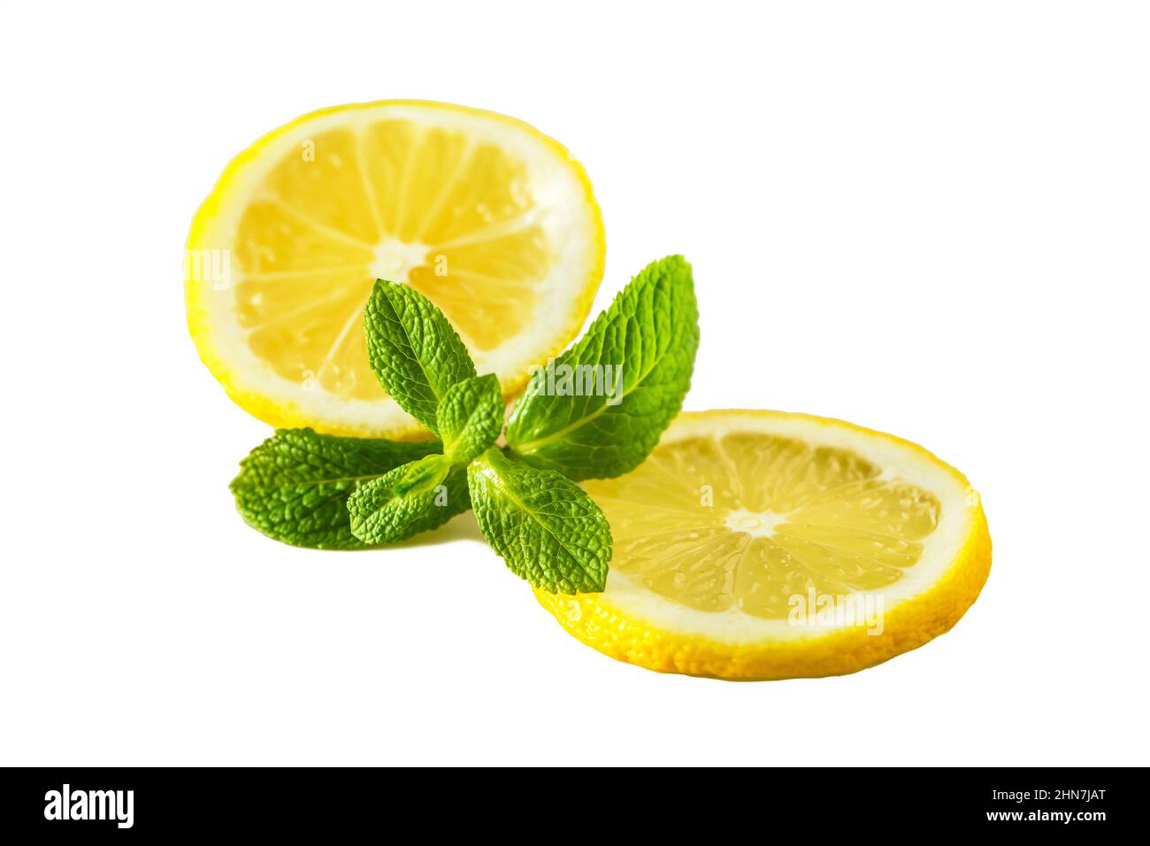 Fresh juicy lemon with mint on white background. Slice of ripe yellow citrus. Fruit high in vitamin C Stock Photo