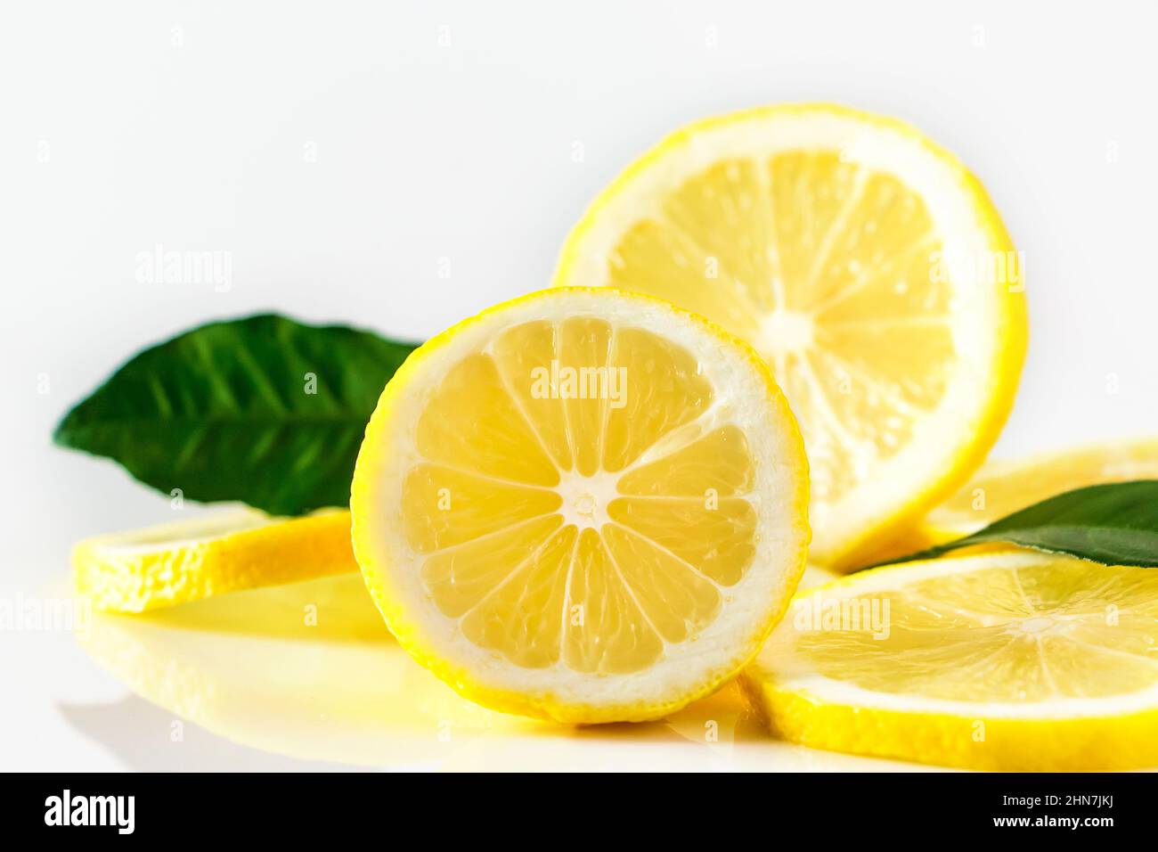 Fresh juicy lemon slices on white background. Citrus fruit high in