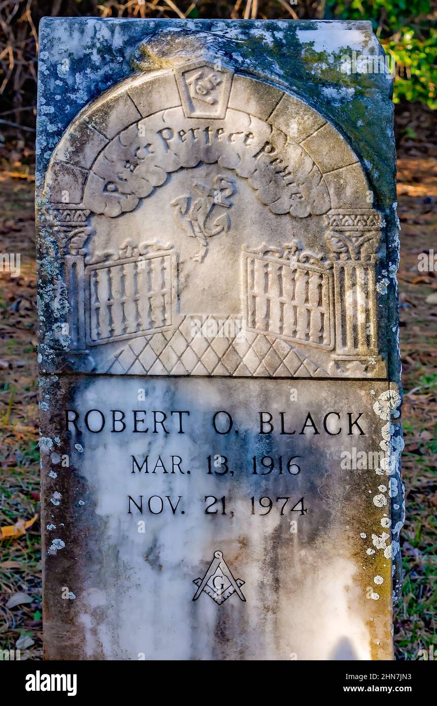 A tombstone features an image of Heaven’s gates and the inscription, “Peace Perfect Peace,” at Dauphin Island Cemetery in Dauphin Island. Alabama. Stock Photo