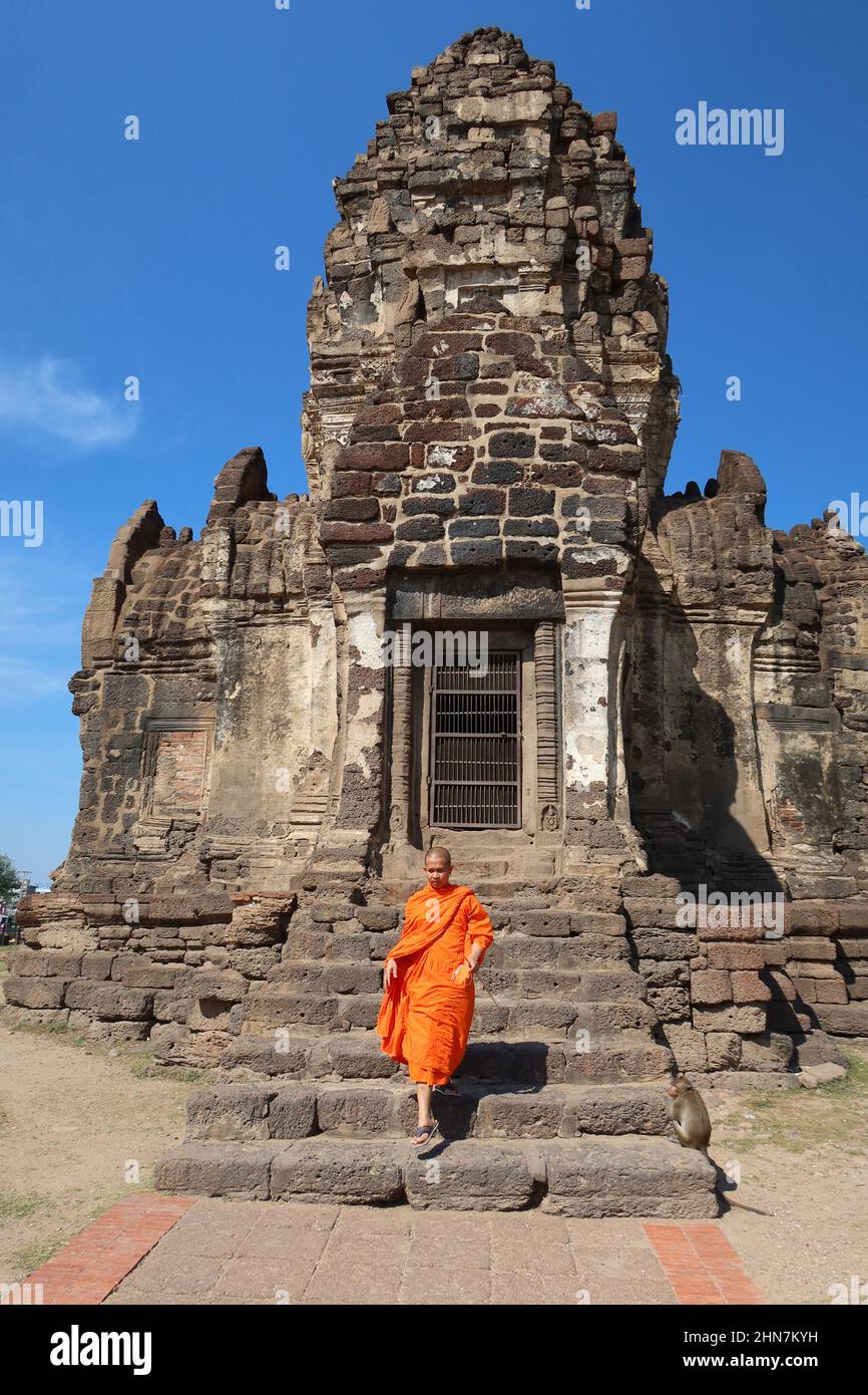 Monk walking down the steps of the Stupa at Phra Prang Sam Yot Buddhist Temple, Lopburi, Thailand Stock Photo