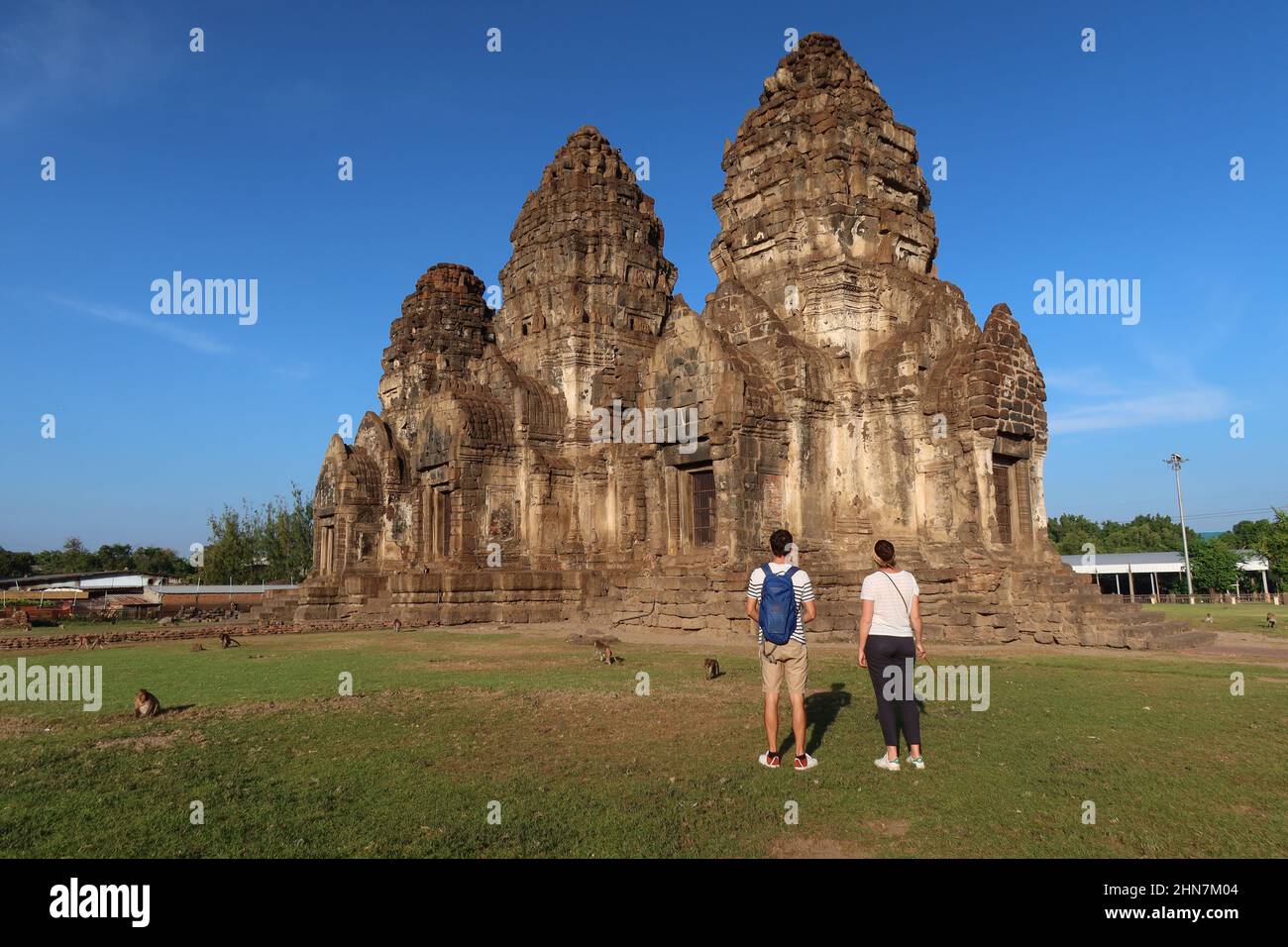 Tourists enjoying the view of the historic Khmer-style Wat Phra Phang San Yot, the Monkey Temple, Lopburi, Thailand. Stock Photo