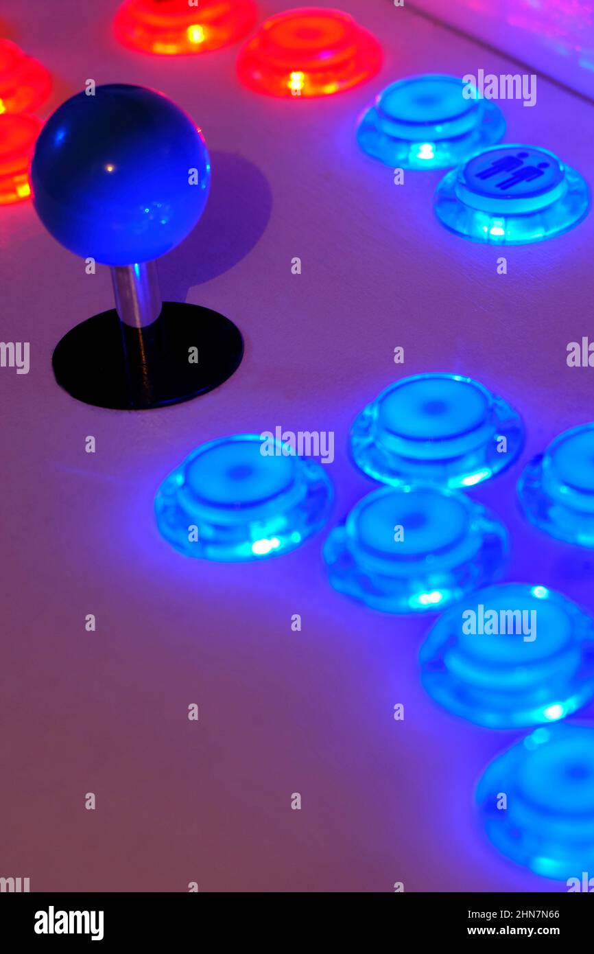 Detail of an old arcade video game blue joystick blue and red buttons