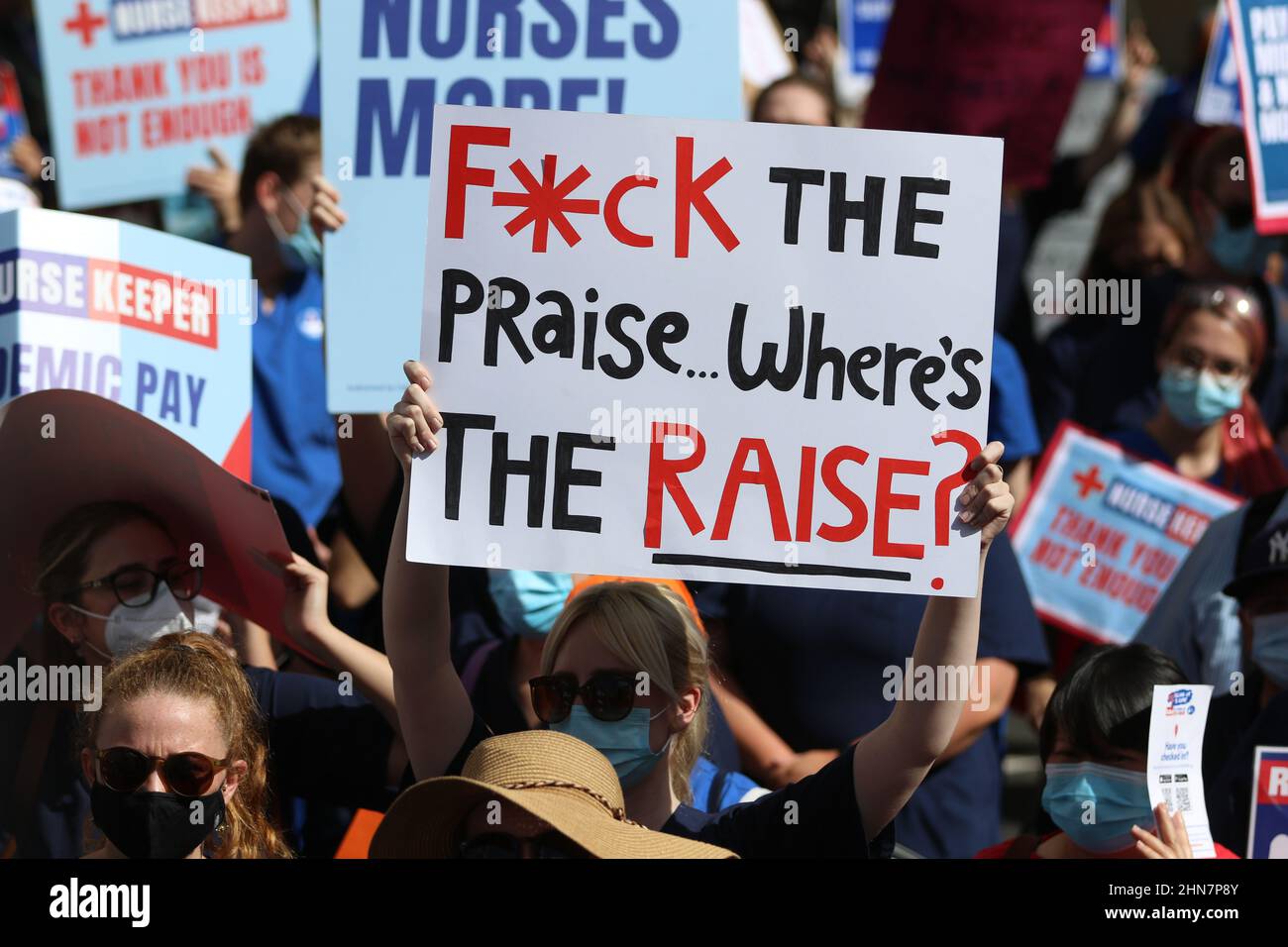 Sydney, Australia. 15th February 2022. NSW nurses strike in defiance of Industrial Relations Commission ruling. Nurses and midwives are asking for a fair pay rise above the 2.5 per cent offered by the NSW Government, and also to be compensated for the pay freeze for government workers implemented in 2020. The union says current staffing levels are inadequate, unsafe and putting patients at risk. They want safe staffing ratios. They also want a Covid allowance. NSW Nurses and Midwives' Association (NSWNMA) members marched from Queen’s Square to the NSW Parliament building on Macquarie Street. Stock Photo